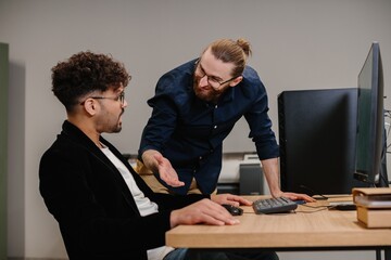Business colleagues collaborating on office project at desk