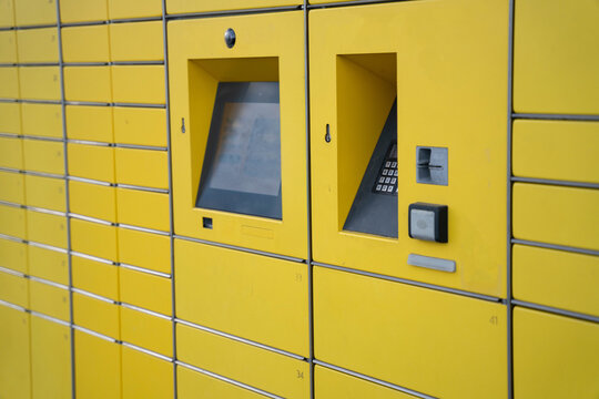 Yellow parcel locker with touch screen and keypad for contactless delivery and online shopping pickup service