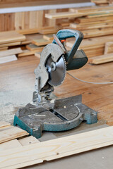 Miter Saw and Cut Lumber on Wooden Floor &ndash; DIY Carpentry Project in Progress