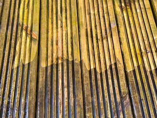 Before and after view of dirt and grime being cleaned from wooden decking using a pressure washer. DIY concept.