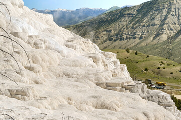 Scenic landscape view of the colourful mineral deposits on Travertine Terraces at the Mammoth Hot Springs in Yellowstone National Park. No people.