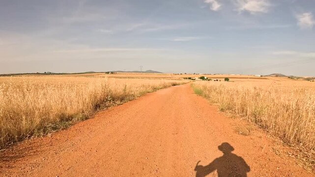 Camino Mozarabe de Santiago - a dirt road on a summer landscape next to Merida, province of Badajoz, Extremadura, Spain