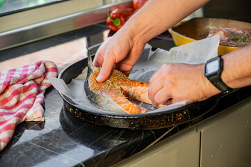 Raw salmon steaks on a baking tray lined with parchment paper.