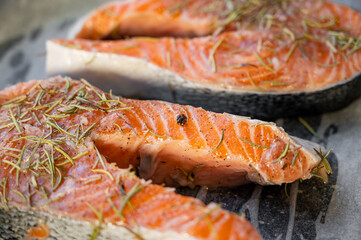 Raw salmon steaks on a baking tray lined with parchment paper.
