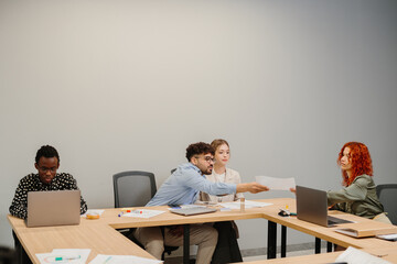 Business team exchanging documents during a corporate meeting