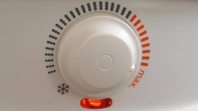 Regulator of temperature of heating water in boiler. Red light indicator comes on - boiler has turned on to heat water. Boiler heats water from cold water supply system