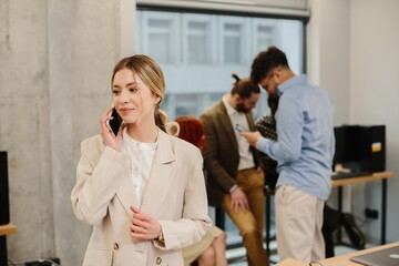 Woman talking on smartphone in business office