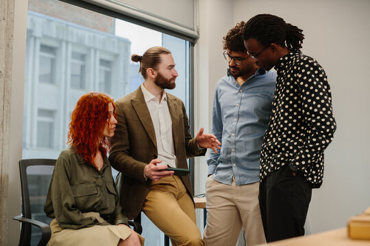 Diverse business team discussing project during meeting