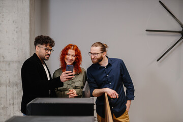 Young business people sharing content on smartphone