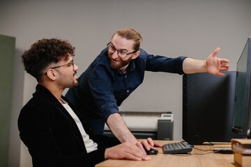 Business colleagues collaborating on computer screen
