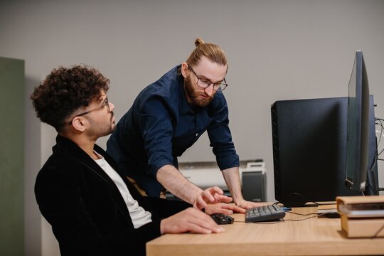 Teamwork and collaboration between colleagues in modern office setting - Powered by Adobe