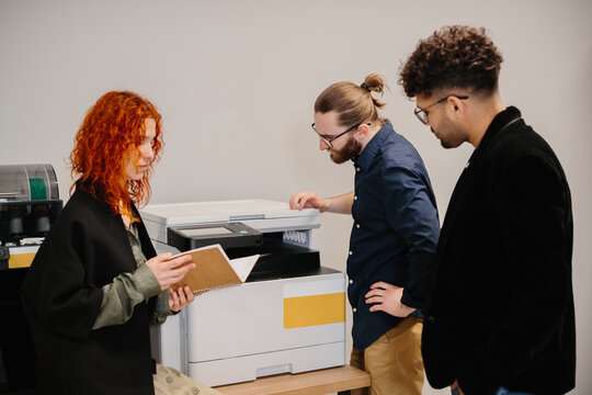 Business people working together using office printer - Powered by Adobe