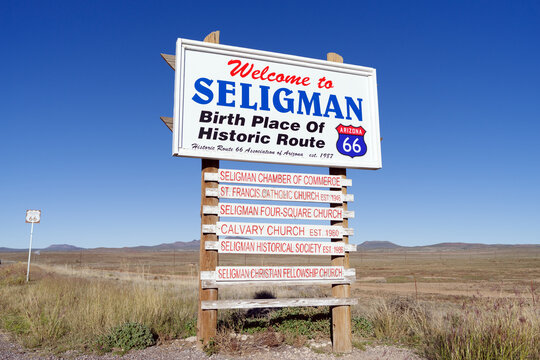 Welcome and information sign in Seligman, Arizona, USA, October 2025. The roadside marker greets visitors to the historic Route 66 town, set against a clear desert sky.