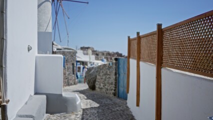 Whitewashed seaside alley defocused with soft shallow bokeh and sunlit white walls, outdoor; background backdrop copyspace calm.