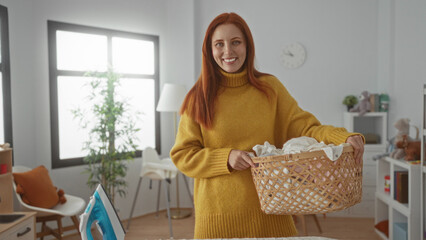 Woman holding laundry basket in cozy room with bright window showing indoor housework scene with...
