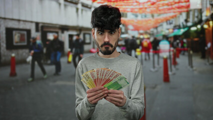 Norwegian man holding banknotes in an urban street scene with blurred pedestrians and vibrant background colors conveying a sense of excitement and prosperity.
