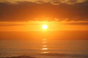 Golden Sunset Over Calm Ocean Horizon with Dramatic Clouds