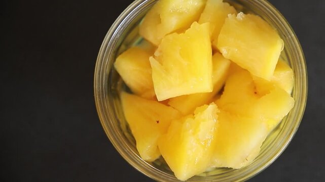 Pineapple canned chunks sweet fruit dessert tasty snack fresh delicious gourmet food background on the table rustic top view copy space keto and paleo diet vegetarian and vegan food