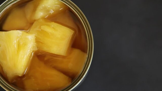 Pineapple canned chunks sweet fruit dessert tasty snack fresh delicious gourmet food background on the table rustic top view copy space keto and paleo diet vegetarian and vegan food