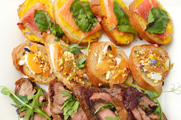 Gourmet platter featuring assorted canapes with smoked salmon, savory meats, and vibrant garnishes, showcasing culinary artistry and elegant presentation for fine dining experiences