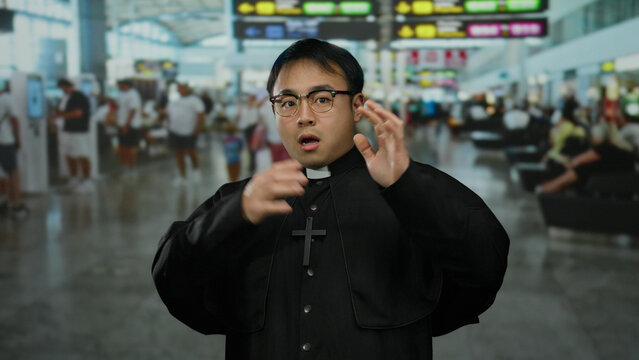 Chinese priest in a bustling airport terminal displaying a worried expression, surrounded by travelers, under bright airport signage, conveying travel anxiety and cultural presence.