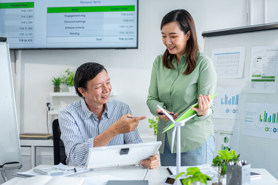 Professionals collaborate on renewable energy project planning environmental impact assessment sustainable business growth - Powered by Adobe