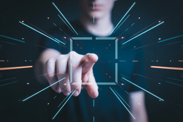 Man pointing index finger at futuristic digital interface with glowing light trails and abstract target square technology innovation concept