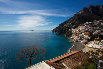 Dramatic view of the Amalfi Coast with whitewashed houses perched on steep cliffs above the deep blue Tyrrhenian Sea