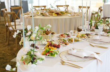 Elegant wedding menu displayed on a beautifully set table with floral arrangements, fine glassware, and delicious dishes, creating a romantic dining atmosphere for guests