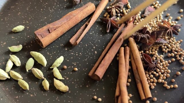variety of spices stands on a board star anise and korea cinnamon cinnamon sticks stir with asian sticks cardamom saffron flavor cooking