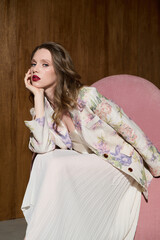 A girl model in stylish clothes in a photo studio