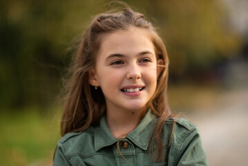 Fototapeta premium Portrait of a happy child girl outside.