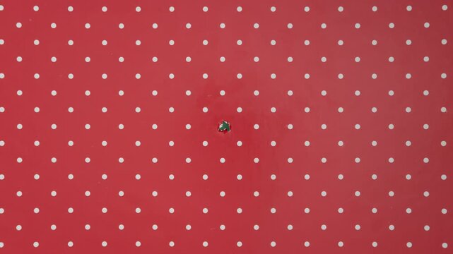 Christmas wrapping paper tears from the center on a green background. Stop motion. Layout for discounts, text, etc