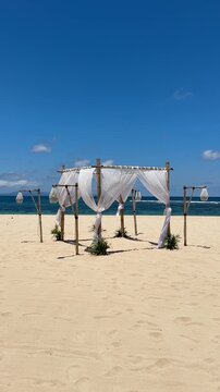 Baldachin Bed on the beach with lanterns, sunny weather on holiday