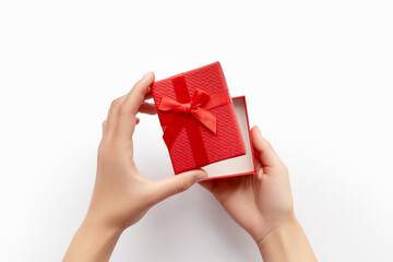 Hands Opening a Red Gift Box Top View