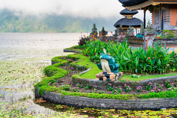 Beautiful sunrise over Pura Ulun Danu Beratan temple Bali showing reflections and tropical landscape
