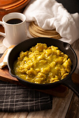 Scrambled eggs in green sauce. A typical Mexican breakfast of scrambled eggs bathed in spicy green sauce, usually accompanied by beans and pot coffee.