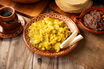 Scrambled eggs in green sauce. A typical Mexican breakfast of scrambled eggs bathed in spicy green sauce, usually accompanied by beans and pot coffee.