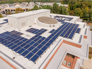 Sunny Daytime Drone Images of the Roof of a Commercial Building Featuring Solar Panels