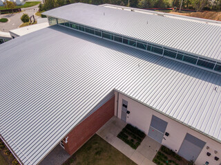 Sunny Daytime Drone Images of a New Commercial Building With A Large Standing Seam Metal Roofing System © Oak City Drone