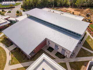 Sunny Daytime Drone Images of a New Commercial Building With A Large Standing Seam Metal Roofing System: Architecture, Roofing, Industry © Oak City Drone