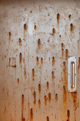 Rusty and pitted metal door perfect for use as a texture in a photo illustration. Seen on an old lighthouse on the island of Kauai, Hawaii.