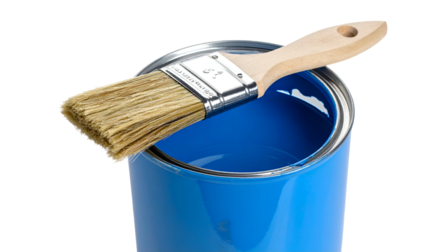 A paint can filled with blue paint and a brush resting on top against a black backdrop