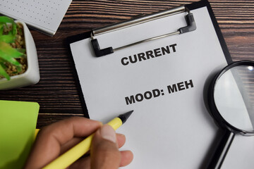 Concept of current mood meh write on clipboard isolated on Wooden Table.