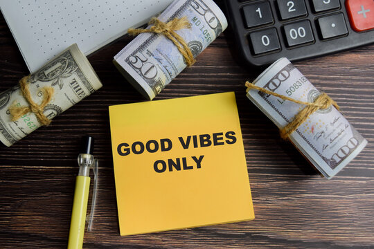 Concept of good vibes only write on sticky notes isolated on Wooden Table.