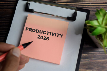 Concept of productivity 2026 write on sticky notes isolated on Wooden Table.