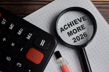 Concept of achieve more 2026 write on book with keywords isolated on Wooden Table.