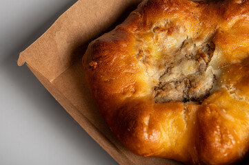 Delicious golden-baked pastry with a savory meat filling, perfectly presented in an eco-friendly...