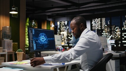 African american worker checking KPI metrics data with artificial intelligence tools on pc, working with AI neural networks for machine learning. Emphasizing innovation.