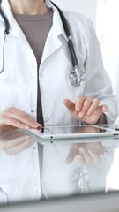 Female doctor uses a digital tablet, provides medical advice and information about health insurance support. Medicine and healthcare